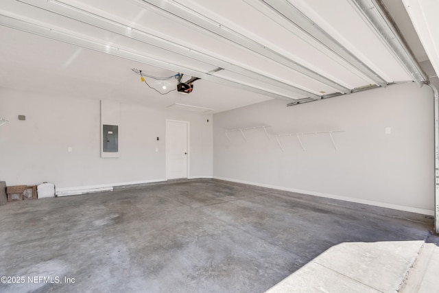 garage featuring a garage door opener, electric panel, and baseboards