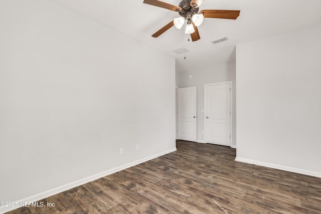 unfurnished bedroom featuring a ceiling fan, dark wood finished floors, visible vents, and baseboards