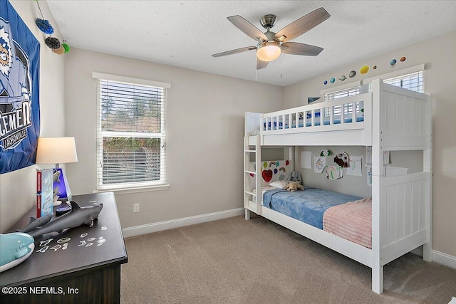 bedroom featuring carpet flooring, a ceiling fan, baseboards, and a textured ceiling