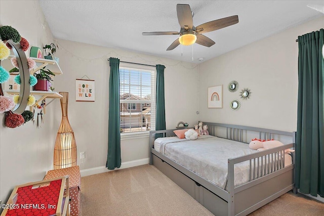 carpeted bedroom with baseboards and ceiling fan