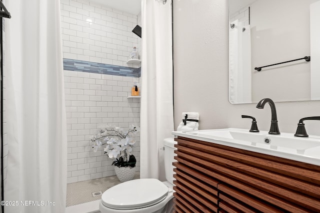 bathroom featuring vanity, toilet, and a shower stall