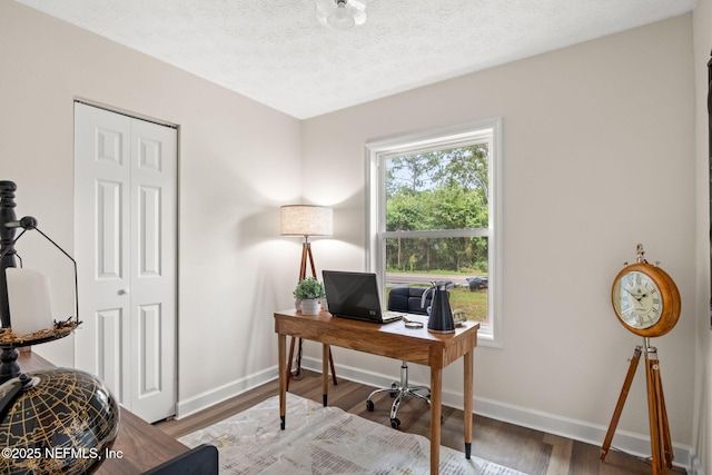 home office with baseboards, a textured ceiling, and wood finished floors