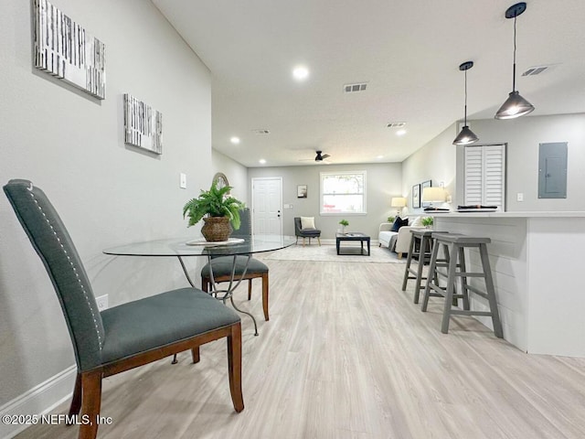 interior space featuring light wood-type flooring, baseboards, electric panel, and visible vents