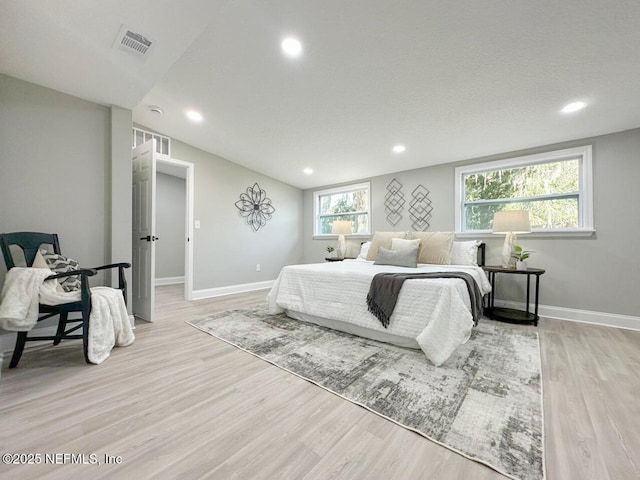 bedroom featuring recessed lighting, light wood-type flooring, visible vents, and baseboards