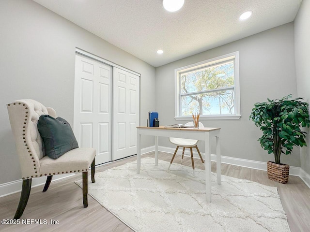 home office featuring a textured ceiling, recessed lighting, wood finished floors, and baseboards