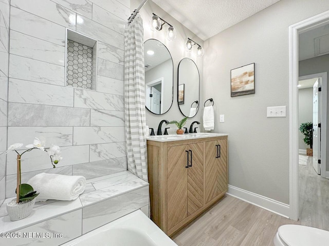 full bath with baseboards, toilet, wood finished floors, a textured ceiling, and vanity