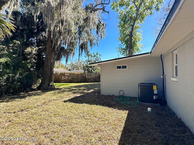 view of yard featuring cooling unit and fence