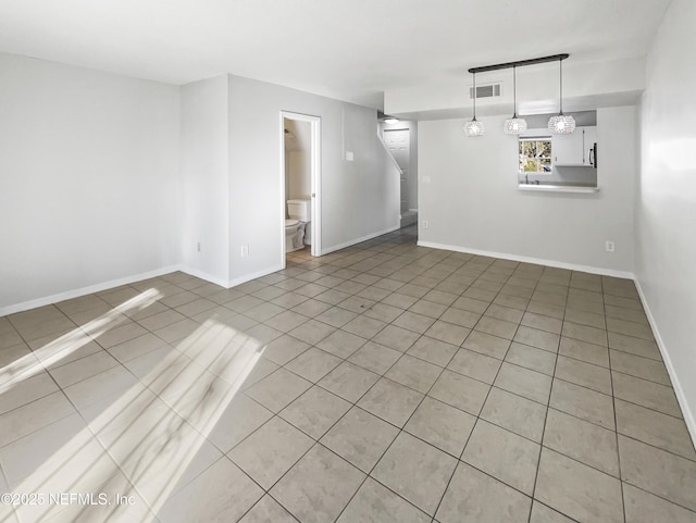 spare room with visible vents and baseboards