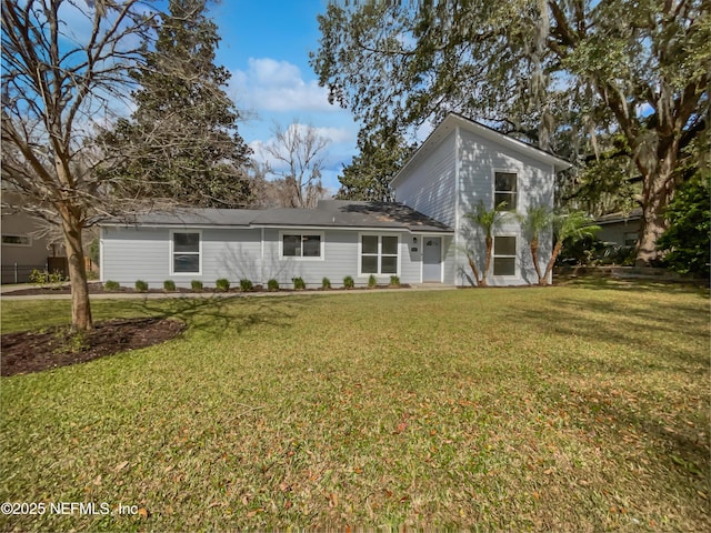 back of property featuring a lawn