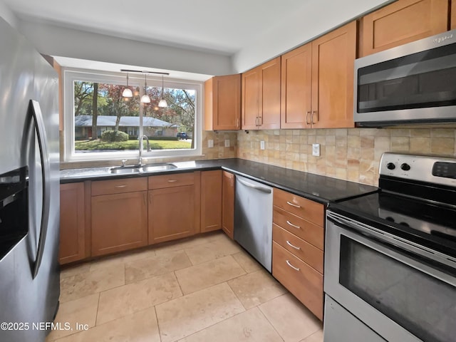 kitchen with light tile patterned floors, a sink, stainless steel appliances, dark countertops, and tasteful backsplash