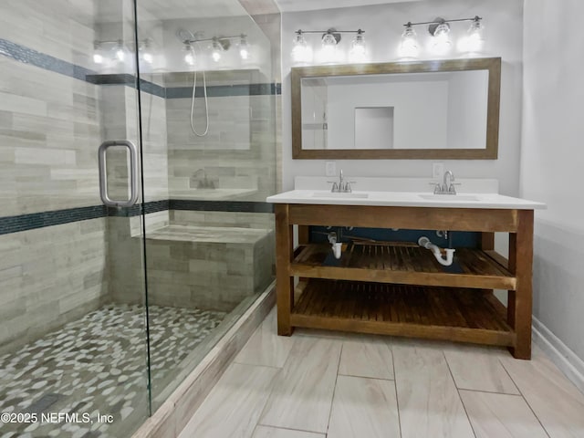 full bathroom featuring a sink, a stall shower, and double vanity