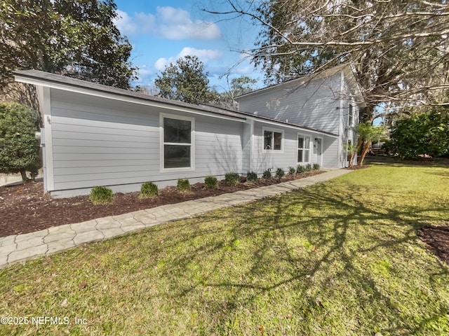 view of side of property featuring a yard