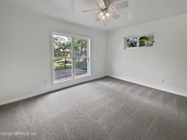 carpeted empty room featuring baseboards, crown molding, and ceiling fan