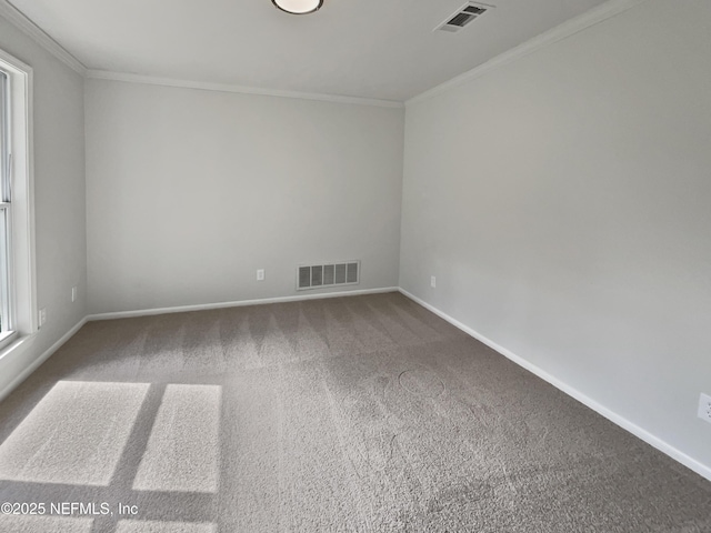 spare room featuring visible vents, baseboards, ornamental molding, and carpet flooring