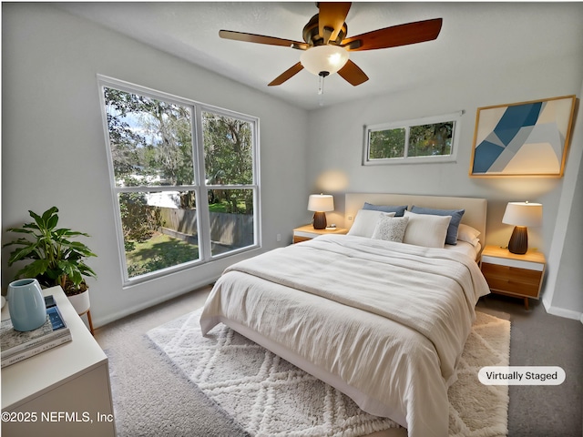 carpeted bedroom with multiple windows, baseboards, and ceiling fan