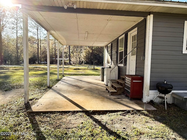 view of patio featuring entry steps, an attached carport, and a grill