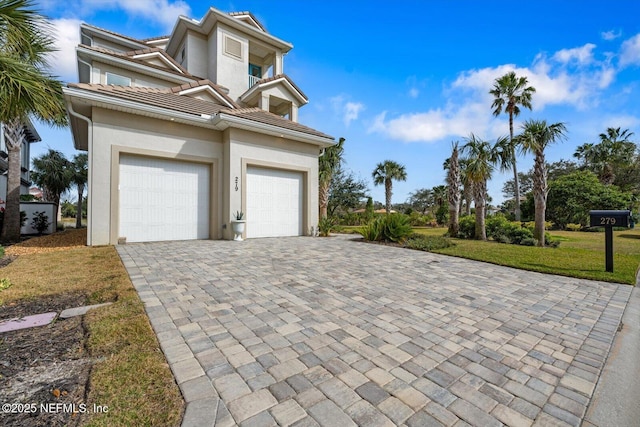 garage featuring decorative driveway