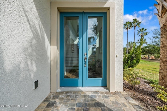 entrance to property featuring stucco siding