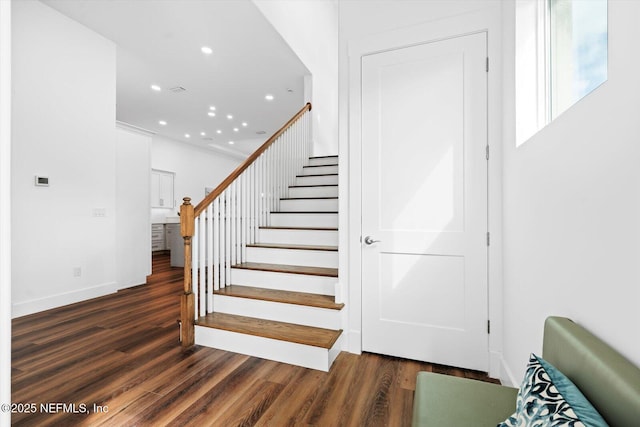 stairs with recessed lighting, baseboards, and wood finished floors