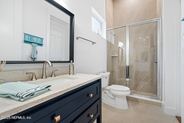 bathroom featuring tile patterned floors, toilet, a stall shower, and vanity