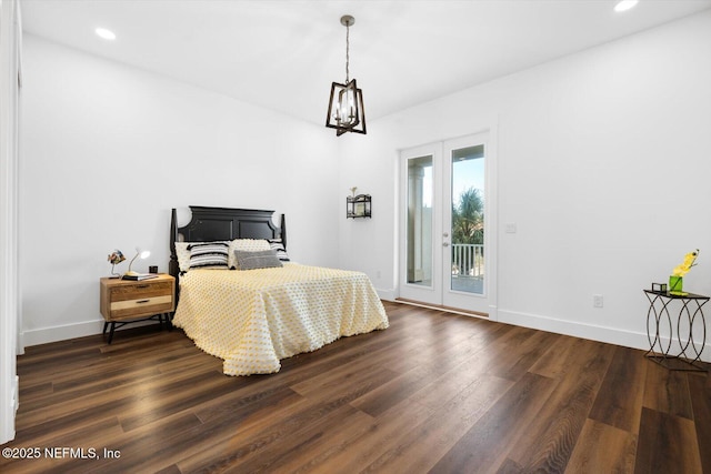 bedroom with access to exterior, dark wood-type flooring, and baseboards