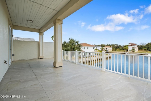 view of patio / terrace featuring a residential view and a water view