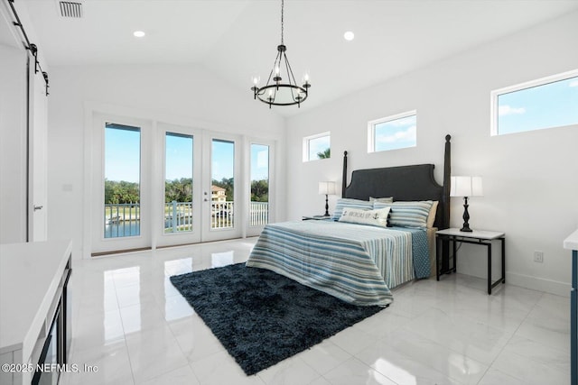 bedroom with visible vents, multiple windows, a barn door, and access to outside