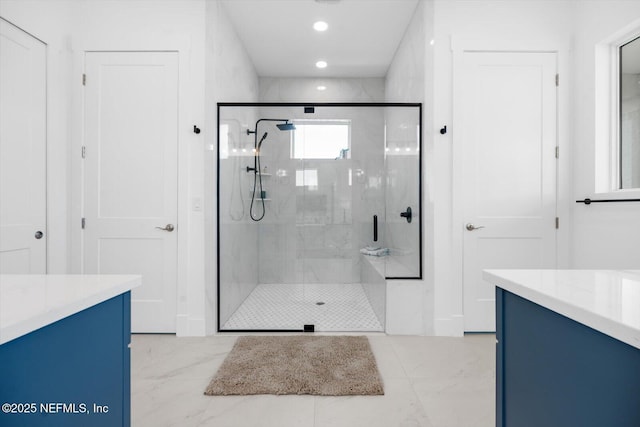 bathroom with recessed lighting, marble finish floor, a stall shower, and vanity