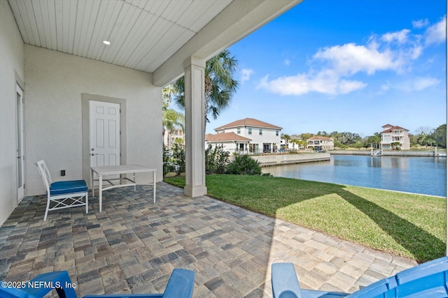 view of patio with a water view