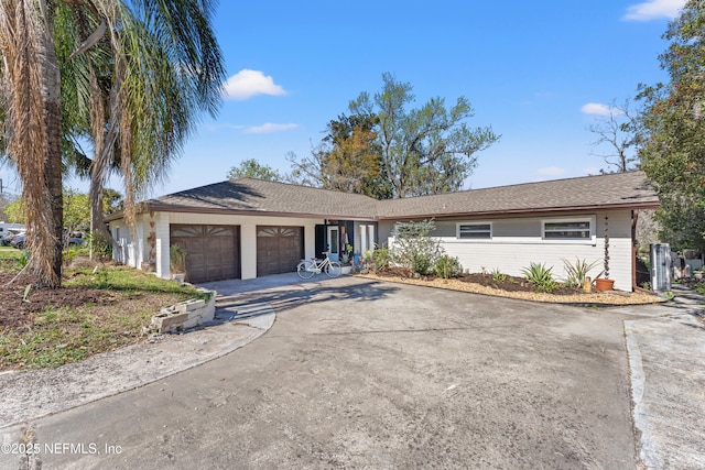 ranch-style home with driveway and an attached garage