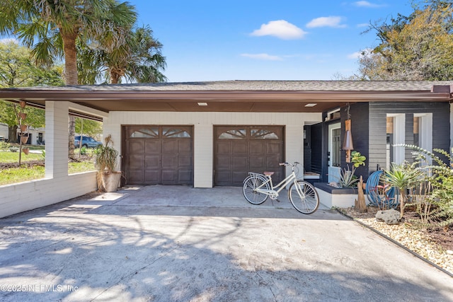 garage with concrete driveway