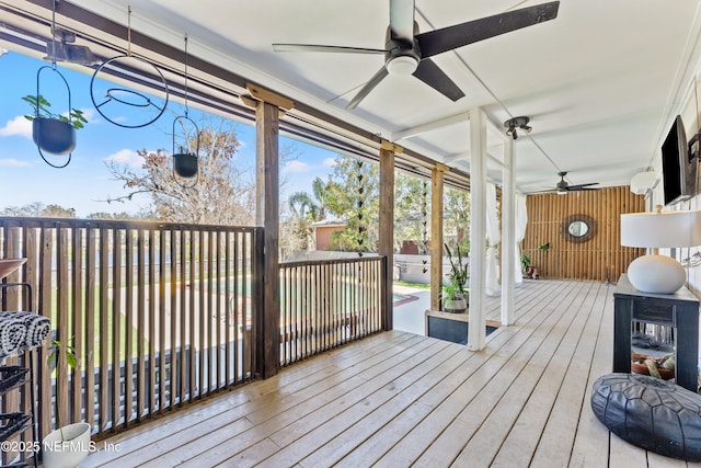 wooden deck featuring ceiling fan and fence