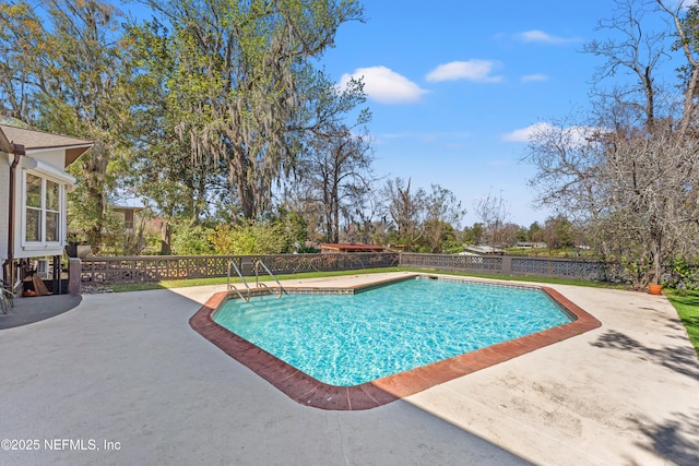 view of swimming pool with a patio, fence private yard, and a fenced in pool