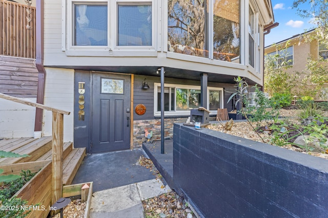 entrance to property featuring stone siding