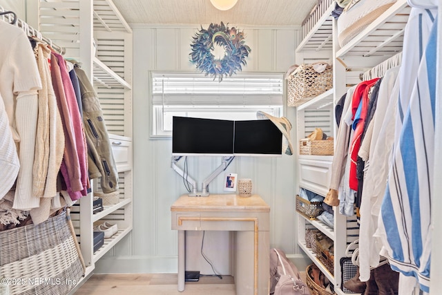 walk in closet with wood finished floors