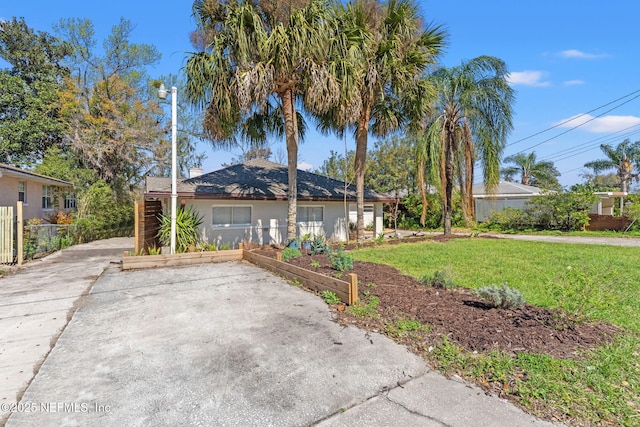 view of home's exterior with fence and a lawn