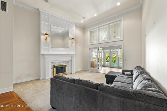 24620 Deer Trace Dr, Ponte Vedra Beach, FL 32082 - living area featuring visible vents, crown molding, baseboards, a premium fireplace, and french doors