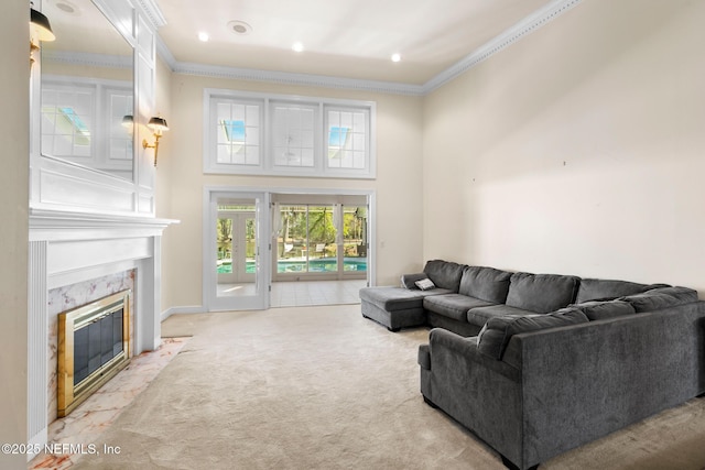 24620 Deer Trace Dr, Ponte Vedra Beach, FL 32082 - living area featuring a premium fireplace, light colored carpet, a towering ceiling, and ornamental molding