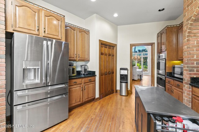 24620 Deer Trace Dr, Ponte Vedra Beach, FL 32082 - kitchen featuring recessed lighting, stainless steel appliances, light wood-style flooring, and brown cabinetry
