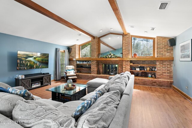 24620 Deer Trace Dr, Ponte Vedra Beach, FL 32082 - living area featuring visible vents, a fireplace, vaulted ceiling with beams, and wood finished floors