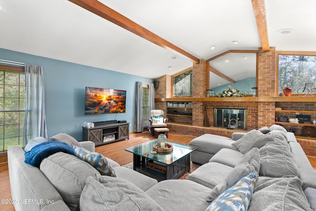 24620 Deer Trace Dr, Ponte Vedra Beach, FL 32082 - living room featuring lofted ceiling with beams, wood finished floors, a brick fireplace, and a wealth of natural light