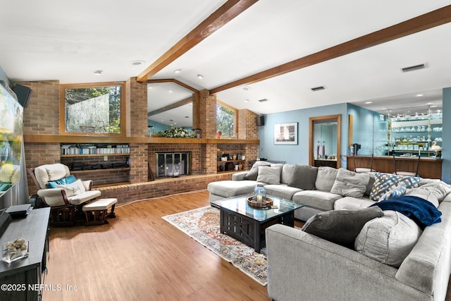 24620 Deer Trace Dr, Ponte Vedra Beach, FL 32082 - living area with a brick fireplace, vaulted ceiling with beams, visible vents, and brick wall
