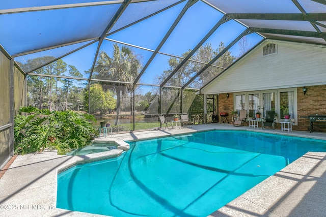 24620 Deer Trace Dr, Ponte Vedra Beach, FL 32082 - view of pool featuring glass enclosure, a patio, french doors, and a pool with connected hot tub