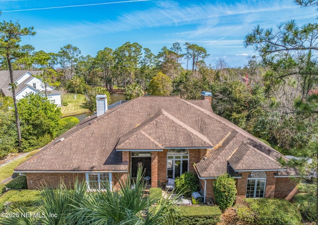 24620 Deer Trace Dr, Ponte Vedra Beach, FL 32082 - view of front of house featuring brick siding, roof with shingles, and a chimney