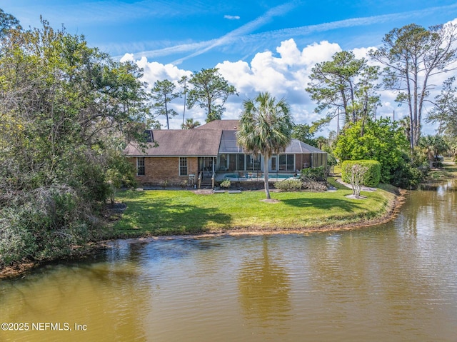 24620 Deer Trace Dr, Ponte Vedra Beach, FL 32082 - rear view of house featuring glass enclosure, a pool, a water view, dirt driveway, and a lawn