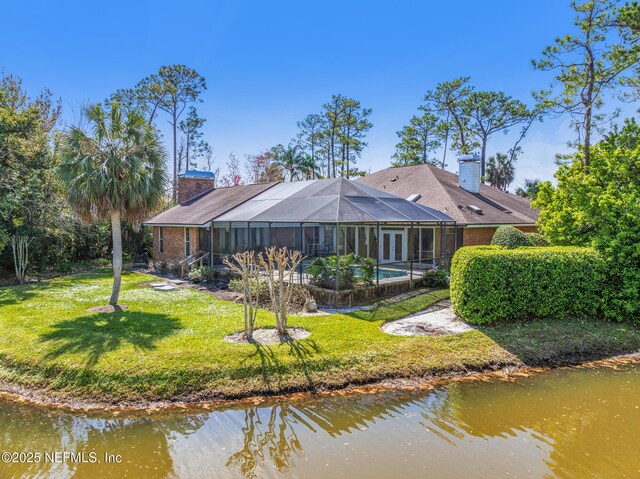 24620 Deer Trace Dr, Ponte Vedra Beach, FL 32082 - back of house with a lanai, an outdoor pool, a chimney, and a yard