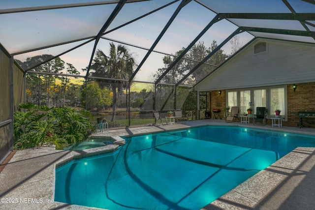 view of pool featuring a patio and a pool with connected hot tub