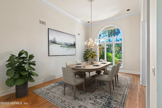 24620 Deer Trace Dr, Ponte Vedra Beach, FL 32082 - dining area featuring an inviting chandelier, crown molding, wood finished floors, and baseboards