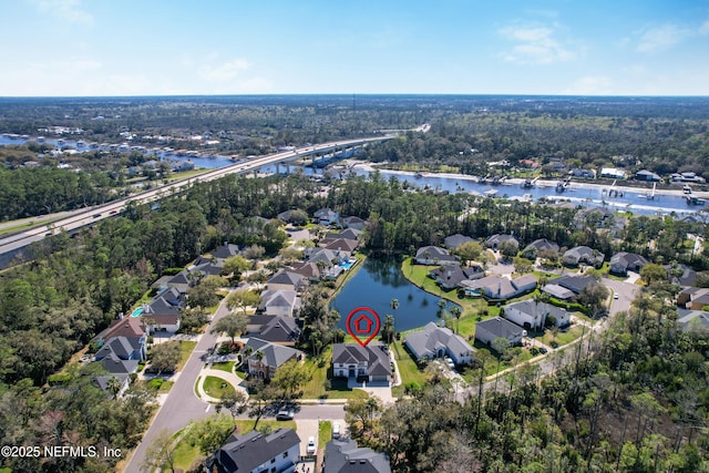 drone / aerial view featuring a residential view and a water view