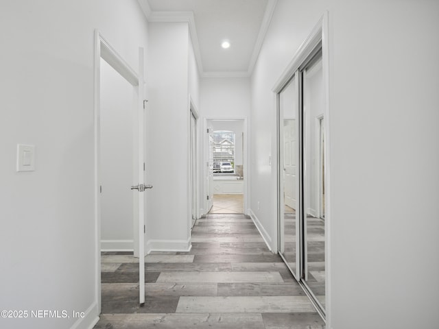 hall with recessed lighting, baseboards, wood finished floors, and ornamental molding